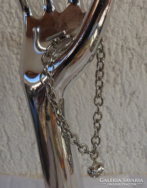 A silver heart with stones on a bracelet