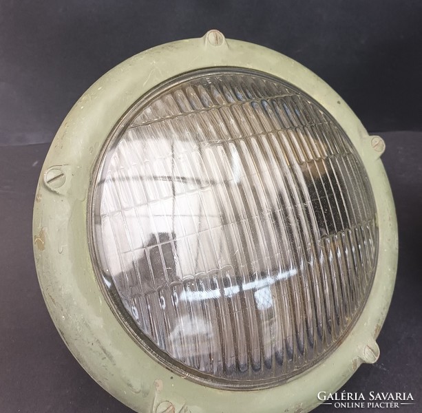 A pair of old military large camouflage headlights