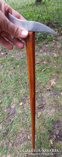 A walking stick with a step-like iron handle head.