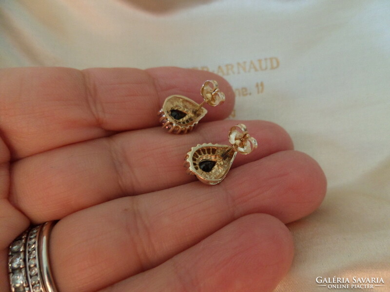Modern gold stud earrings with a pair of blue sapphires and glasses