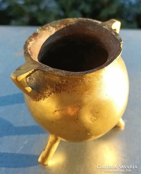 Antique thick-walled bronze three-legged vessel