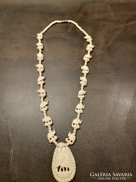 Bone necklace with elephant pendant and chain links. In very nice condition