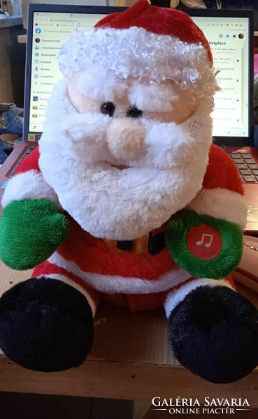 A soft plush Santa singing a cute jingle bell