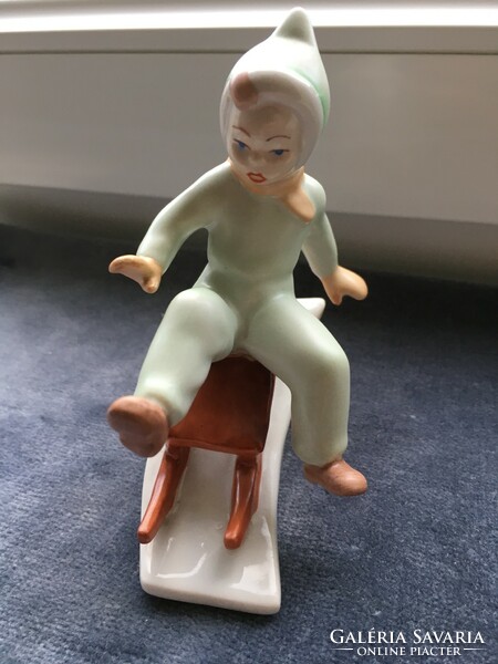 Little girl sledding - old porcelain figure from Aquincum