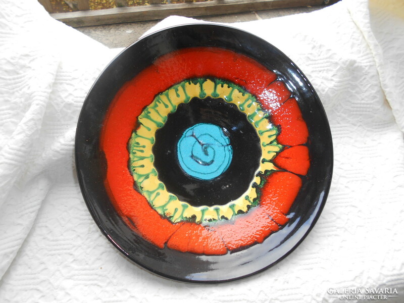 Large, brightly colored ceramic wall plate