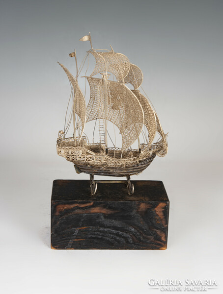 Silver filigree ship model on wooden pedestal