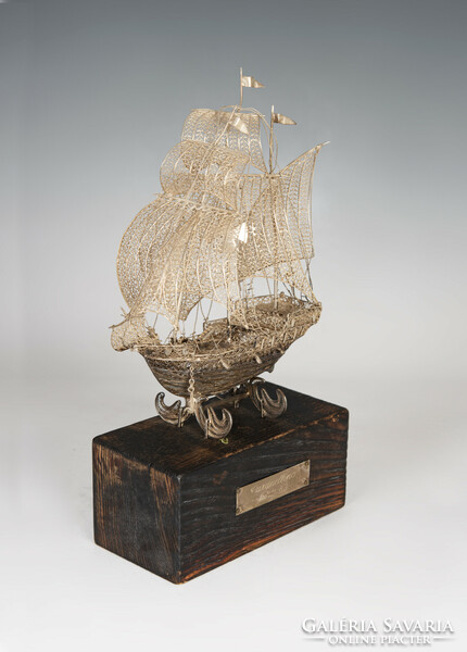 Silver filigree ship model on wooden pedestal