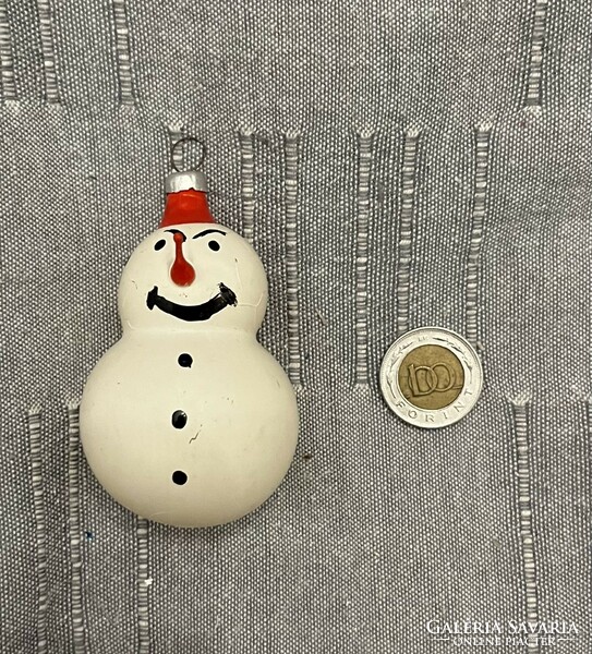 Old retro snowman with glass Christmas tree decoration