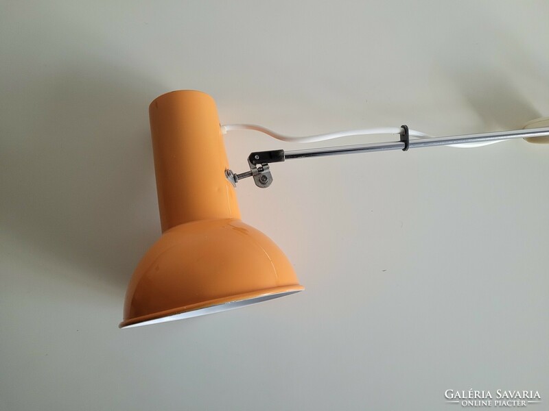 Orange colored old retro long arm adjustable desk lamp mid century