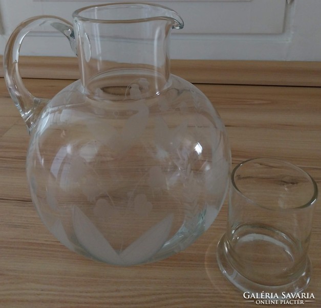 A large glass jug with a polished, beautiful pattern.