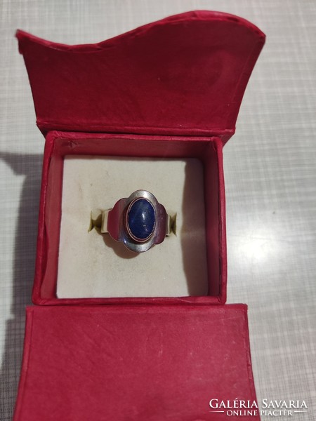 Silver ring with a lapis lazuli stone in a plate setting