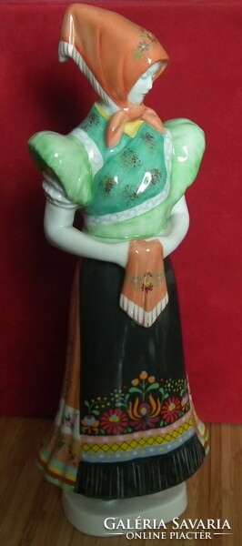 Hollóházi - matyó woman dressed in folk costume with a keškenen