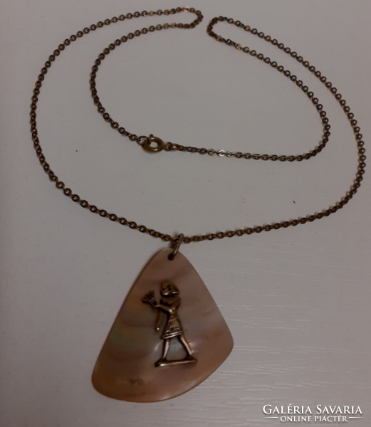 Retro handmade shell pendant with a brass pharaoh figure on a long chain