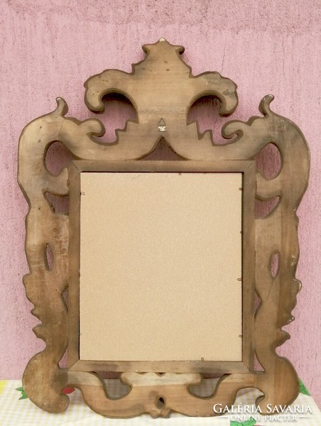 A robust mirror with a baroque style Florentine frame, a unique contemporary piece