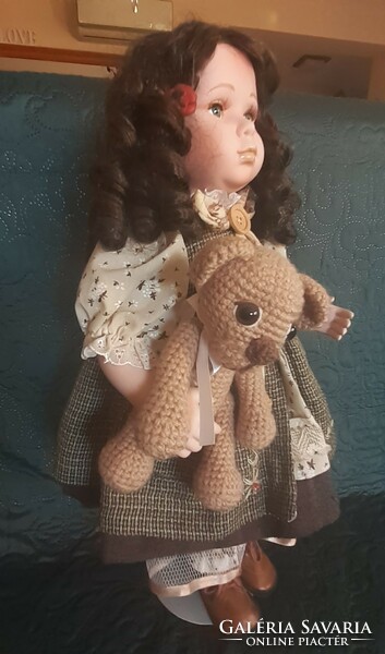 Porcelain doll with teddy bear, stand