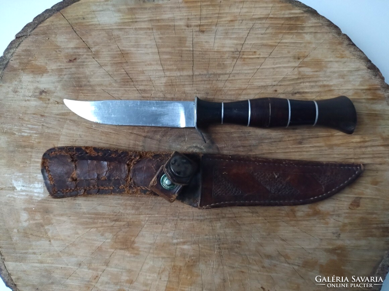Old steel hunting knife with leather sheath