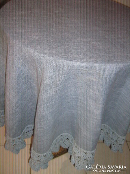 Beautiful gentian blue hand-crocheted round woven tablecloth with lacy edges