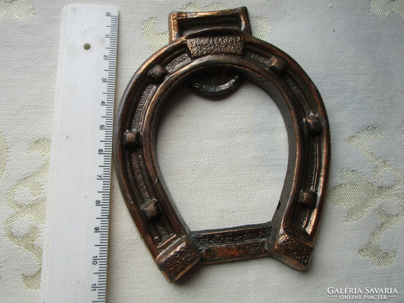 A horseshoe-shaped metal object might be a beer opener