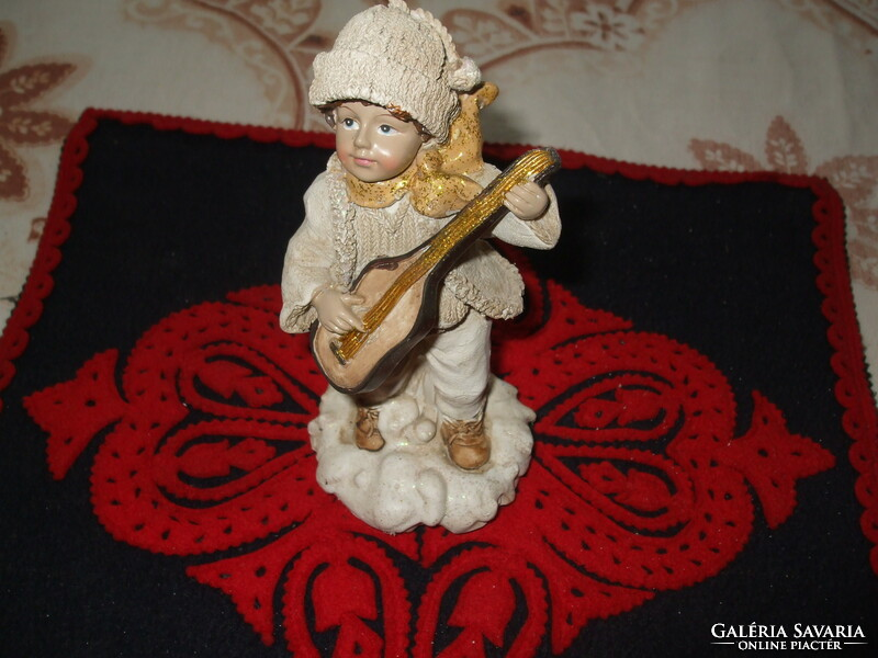 Lifelike, beautifully crafted little boy with a guitar, height: 15 cm