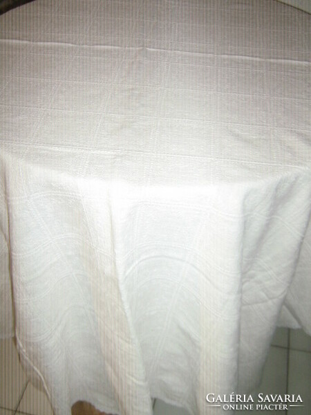 A filigree woven tablecloth with a beautiful madeira lace edge material