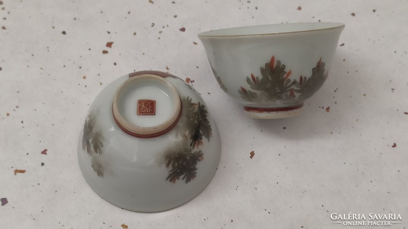 A pair of Japanese sake cups with figures from the no theater