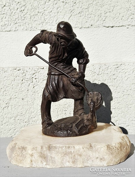 Antique cast iron foundry worker statue on a marble plinth marked 