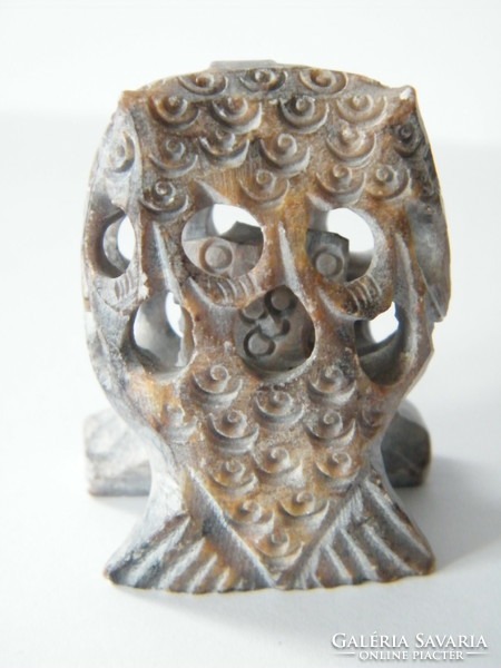 Hand-carved stone owl with a smaller owl inside