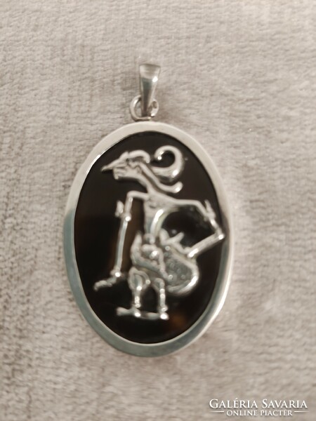 Silver pendant with barong dancer depiction
