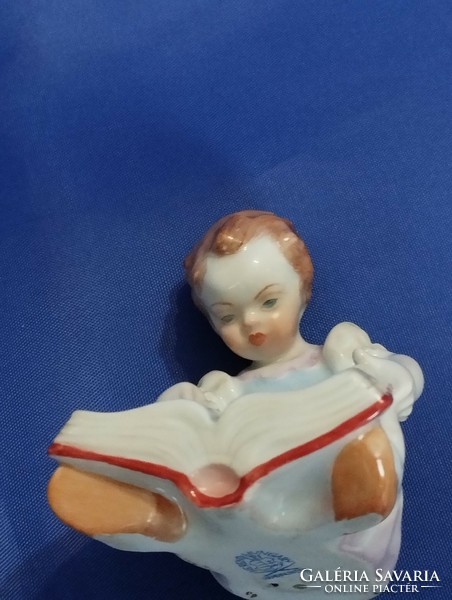 Little girl reading a storybook from Herend