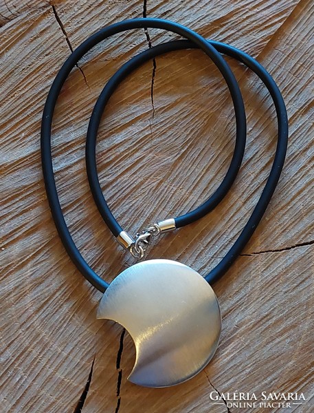 A very special silver moon pendant on a rubber chain