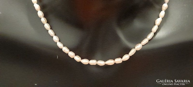 Freshwater rice grain cultured pearl string of 4-6 mm pearls.