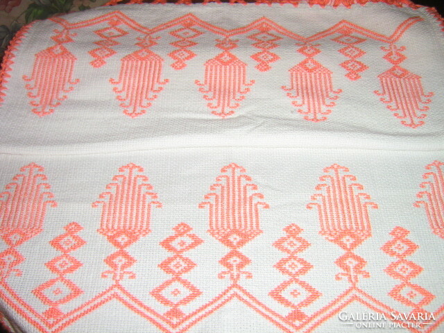 Beautiful hand-embroidered fringed woven tablecloth or towel on a white background