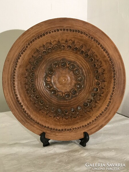Unglazed raw marked ceramic wall plate. Rustic wall decoration