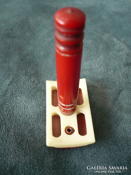 Old plastic travel safety razor with a red handle