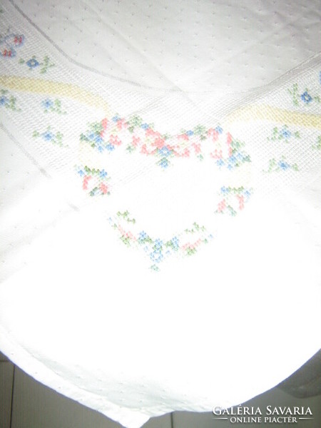 Beautiful white hand-embroidered damask tablecloth with tiny cross-stitch floral hearts and butterflies