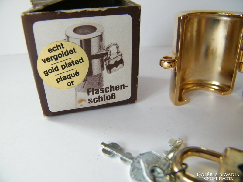 Gold-plated, padlocked glass stopper and cap