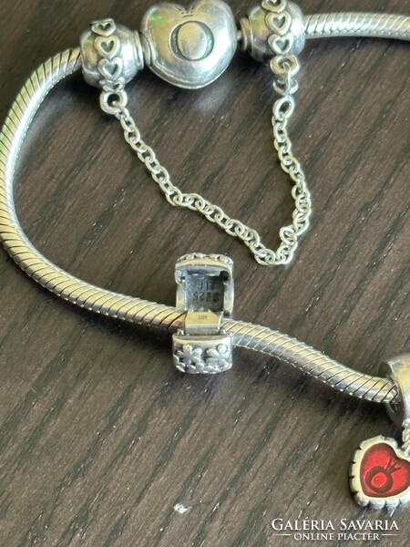 Silver pandora bracelet with several charms