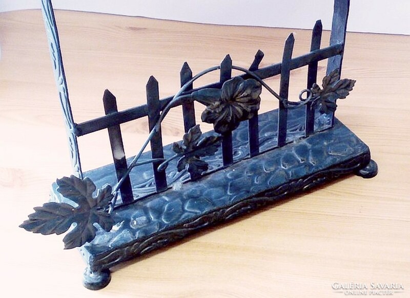 Wrought iron cottage-shaped fireplace with quartz structure and extruded metal decorative elements