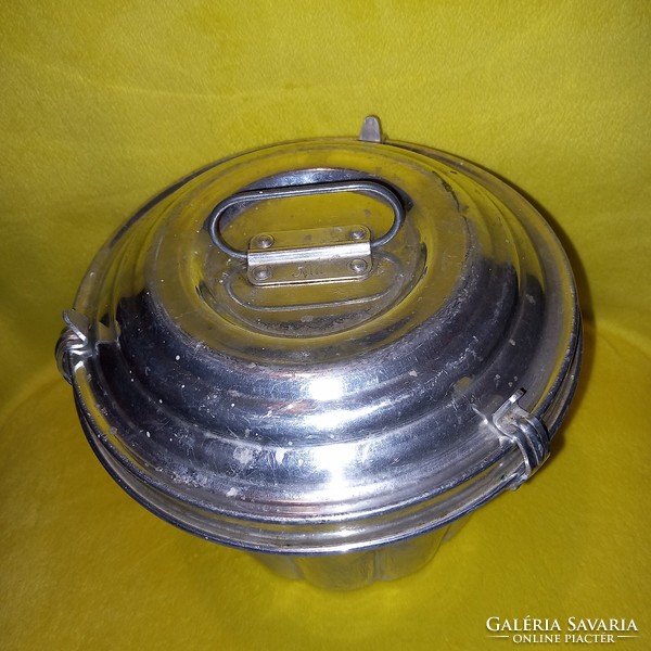 Old, hot-water, aluminum kuglóf baking dish with a lockable lid.