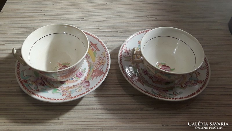 2 antique oriental-patterned faience tea cups with a small plate.