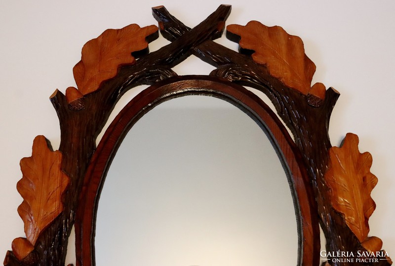Mirror in a carved wooden frame, decorated with a hunting motif