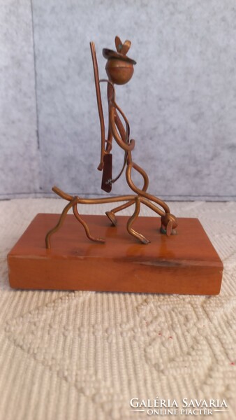 Stylized copper table decoration, hunter and his dog on a hardwood plinth, artistic work.