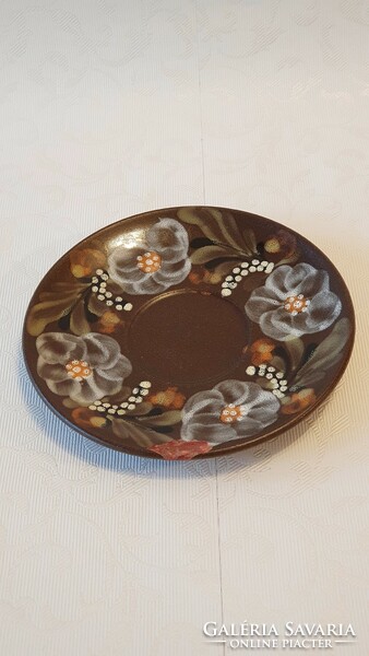 16 cm diameter, damaged, painted ceramic plate with flowers. Under the tile.