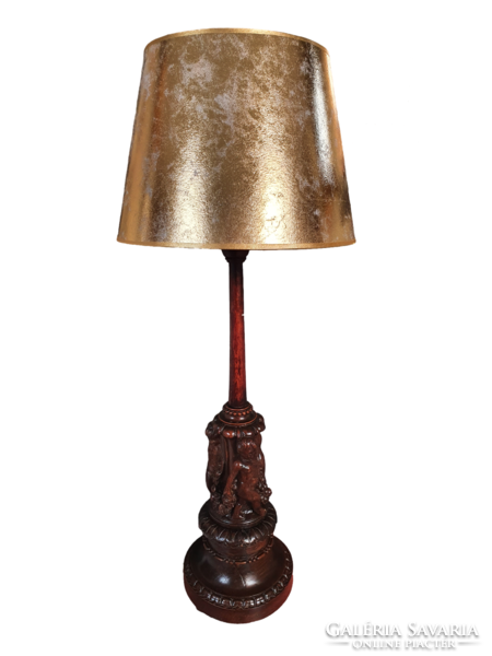 Antique table lamp with a carved, sculpted wooden base