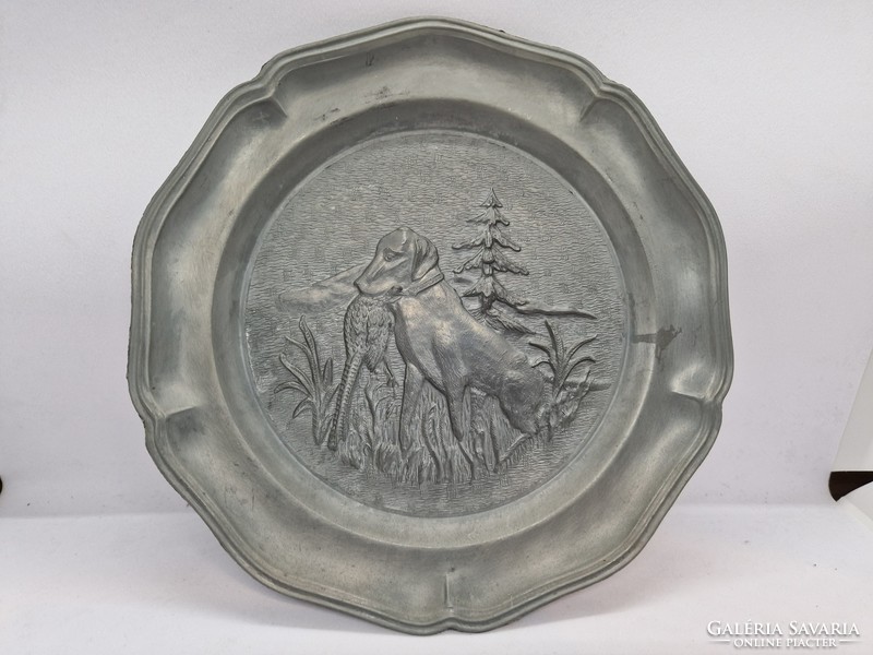 A pair of pewter wall decorations with a hunting scene