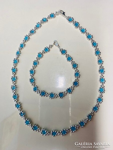 Elegant laced necklace and bracelet made of polished light blue Austrian crystal pearls