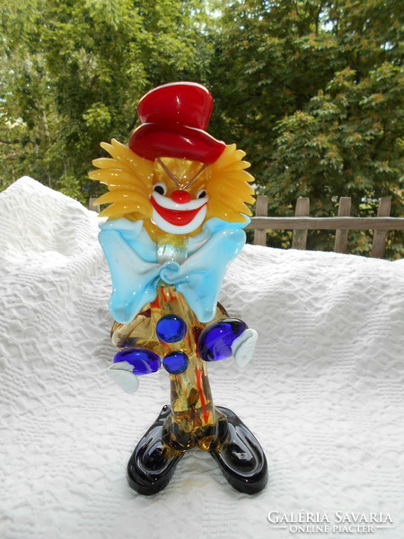Handcrafted glass from Murano kept in a display case with a clown image,