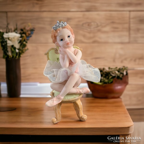 Little ballerina sitting on a vintage chair, Italian