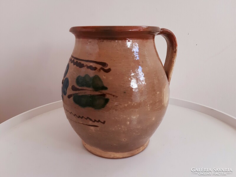 Old painted flower-patterned glazed mug