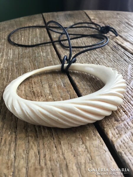 Large carved bone pendant on cord necklace